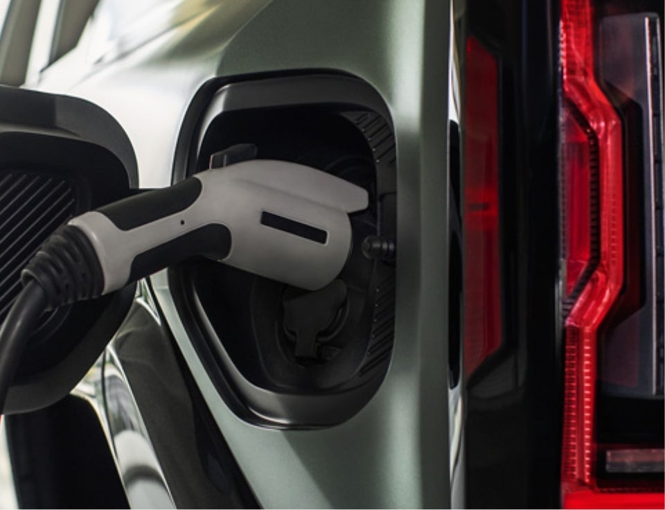 Close up of charging port with charger plugged in on a GMC Hummer EV SUV - Moses GMC of Charleston in Charleston WV